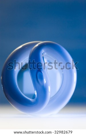 Compact fluorescent bulb with blue glow, isolated on blue background.