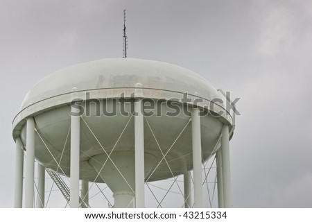 The top of a water tower, isolated against an overcast sky