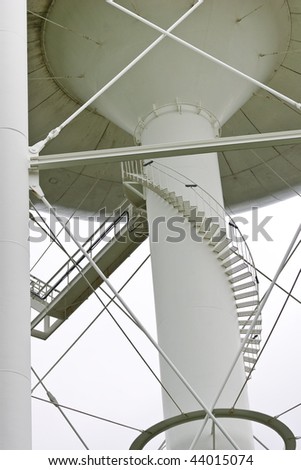 The main supporting column beneath a water tower, including the winding staircase that leads to the top.