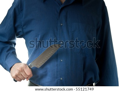 The mid-section of a man in a blue dress shirt, holding a large knife, isolated on white.