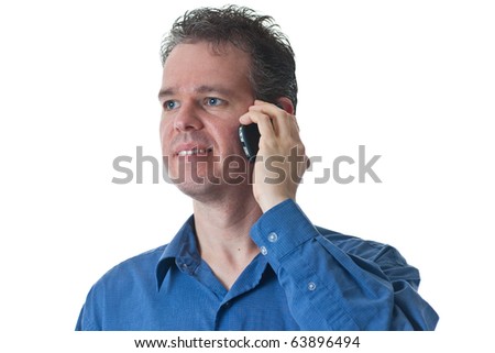 A man in a blue dress shirt, talking on a cellular phone, isolated on white.