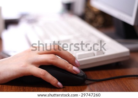 close up of a female hand laying on the computer mouse