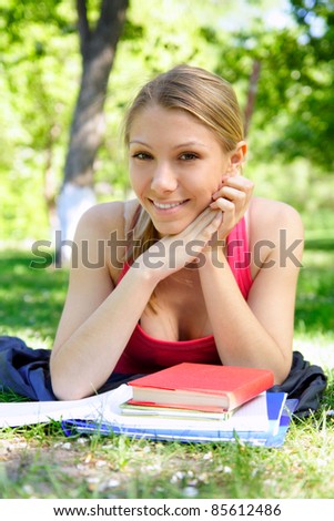 young beautiful woman with the books outdoors