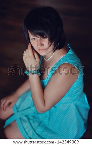 portrait of a glamorous woman in a turquoise dress with a stylish haircut