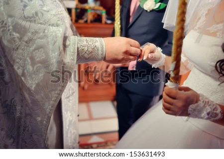 The wedding ceremony in the church priest wears wedding ring