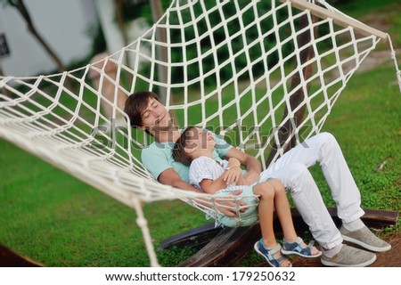 a summer day on the nature of the father and son rest in the big white hammock