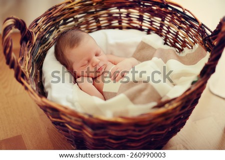 in a wicker basket brown cute sleeping baby