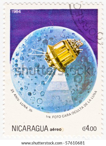 NICARAGUA - 1984: A stamp printed in Nicaragua shows an image of Luna 3 over the moon for the 25 Anniversary of the Soviet space probe, circa 1984