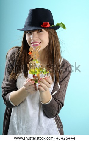 happy girl showing easter ornament