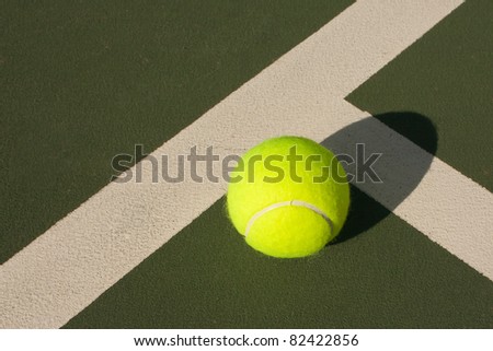 New yellow tennis balls on a green court
