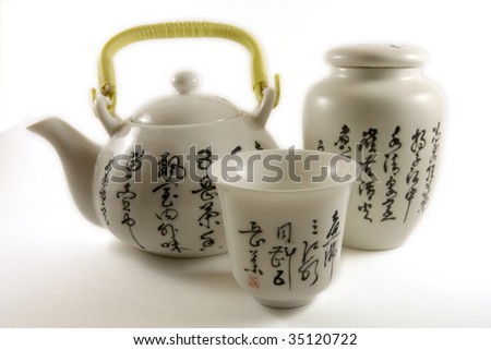 Chinese tea pot with tea cup and tea leaf container with chinese writings