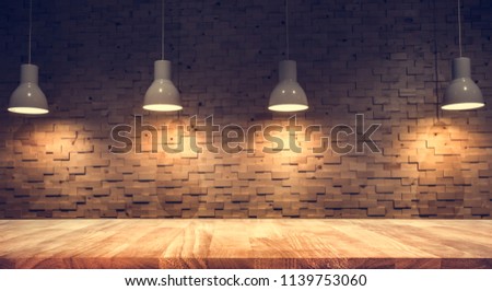 Wood table top on blurred of counter cafe shop with light bulb background.For montage product display or design key visual layout.