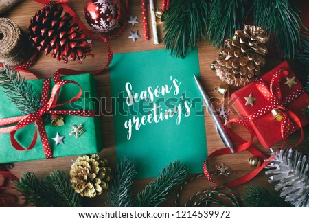 Season\'s greeting\'s concepts with cards and gift box present,ornament element on wood table background.Merry christmas and winter collection images