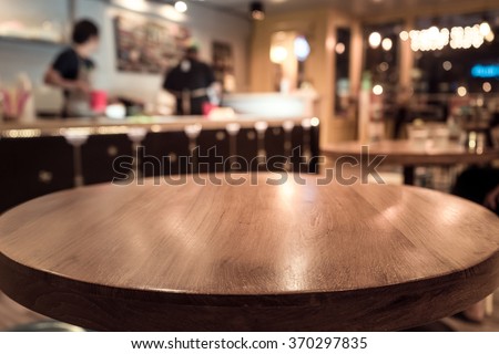 Empty wod table top with blur of people in coffee shop or cafe restaurant background.For montage product display