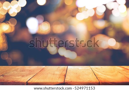 Empty of wood  table top with  blurred light gold bokeh abstract background.For montage product display or design key visual layout