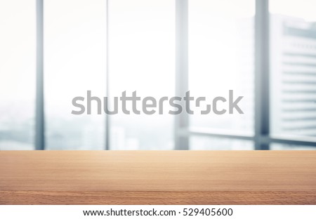 Empty wood table with blur room office and window city view background.For montage product display or design key visual layout.