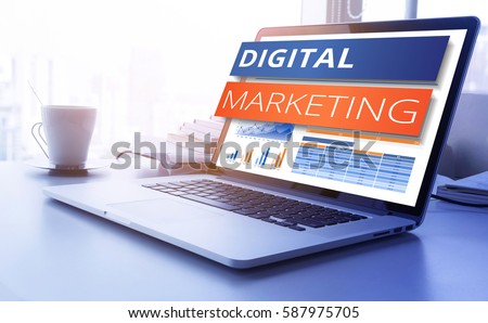 Digital marketing text on modern laptop screen with graph chart background. business marketing, success and goals concept