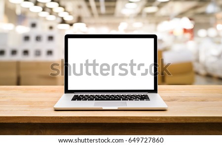 Modern computer,laptop with blank screen on table with blur store factory background