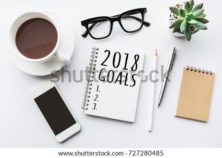 2018 goals text on notepad with office accessories.Business motivation,inspiration concepts