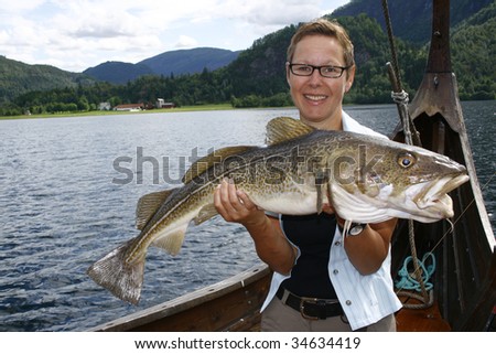 Sport fisher shows a big cod