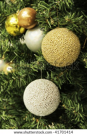 Christmas Ornament. Golden and silver sphere ornament on christmas tree