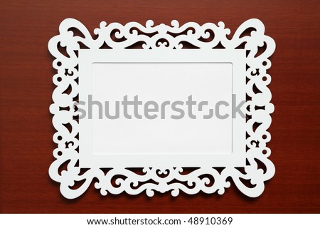 Picture Frame for Home Decoration. White modern photo frame on wooden background.