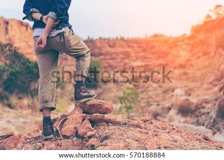 Hiking man, climber or trail runner in mountains, inspirational landscape. Motivated hiker looking at beautiful view. Trekking, travel and tourism concept. Fitness and healthy lifestyle.