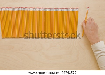 Picking Pencils - Hand picking pencil from perfect row