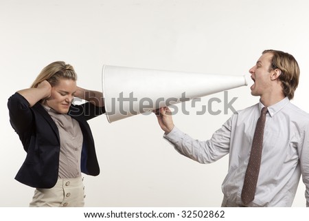 business man yelling through megaphone at business woman