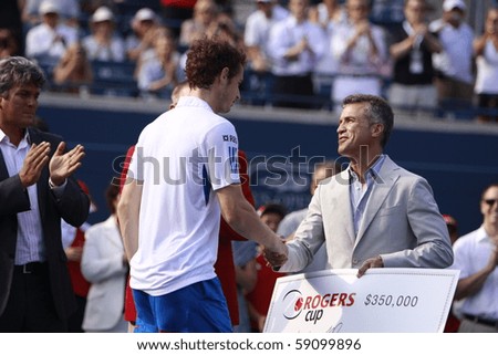 TORONTO: AUGUST 15. Andy Murray gets his price after he won a tournament with Roger Federer in the Rogers Cup 2010 finals on August 15, 2010 in Toronto, Canada.