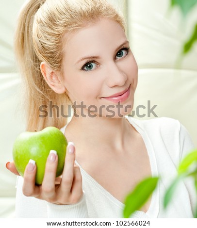 The young beautiful woman with apple