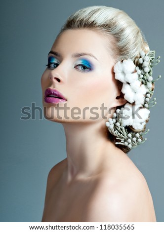model with a professional makeup and flowers in her hair