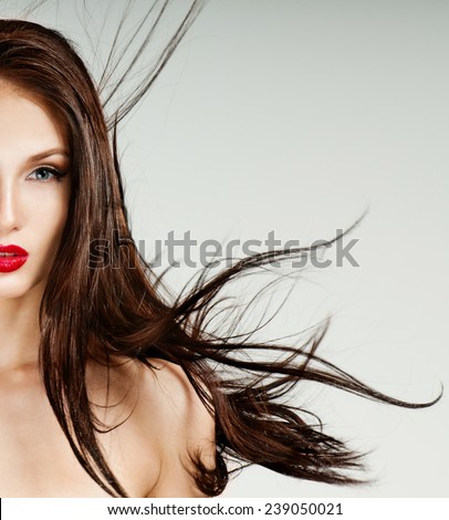 Beautiful woman with magnificent hair. Flying hair. Red lipstick.