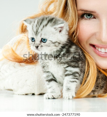 Beautiful young woman and her little kitten. Cute kitten.