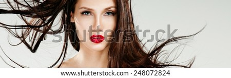 Beautiful woman with magnificent hair. Flying hair. Red lipstick.