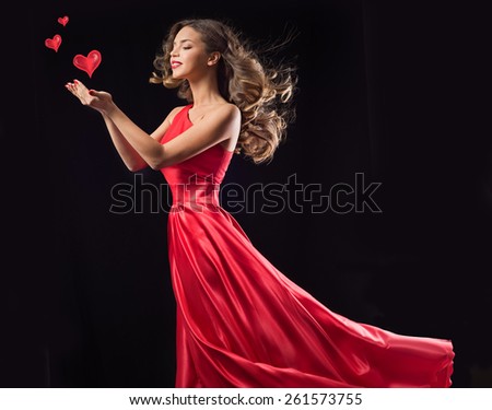 Young beauty woman in red waving flying  dress. Dancer in silk dress. Valentine\'s Day