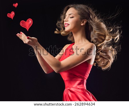 Young beauty woman in red waving flying  dress. Dancer in silk dress. Valentine's Day