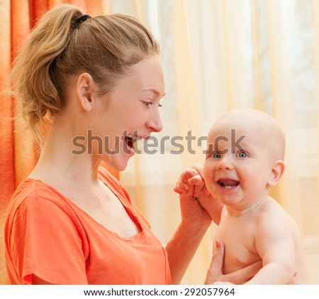 Mother and baby playing and smiling. Happy family.Home interior.