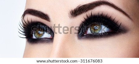 Closeup shot of woman eye with evening makeup. Long eyelashes. Smokey Eyes.