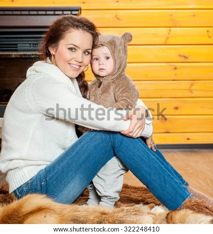 Mother and baby playing and smiling. Happy family.Home interior. Winter season.
