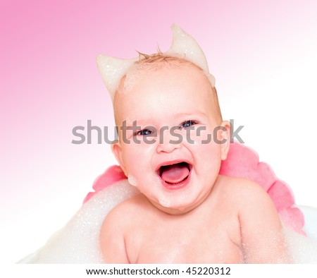 The baby washes in a bathroom with foam
