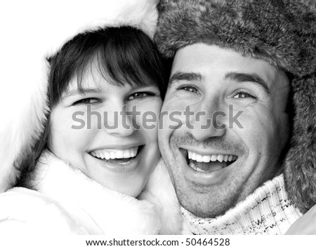 The young woman and the man dressed in fur caps laugh, isolated on a white background