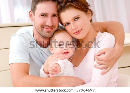 Young, happy family in a room interior