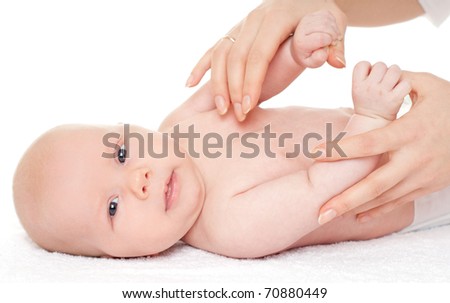 baby is enjoying massage from mother