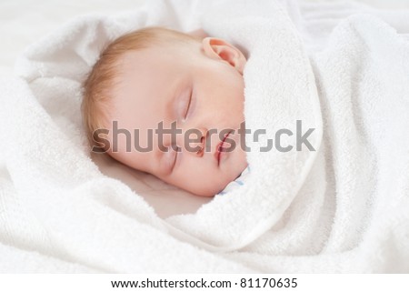baby sleep under a white blanket