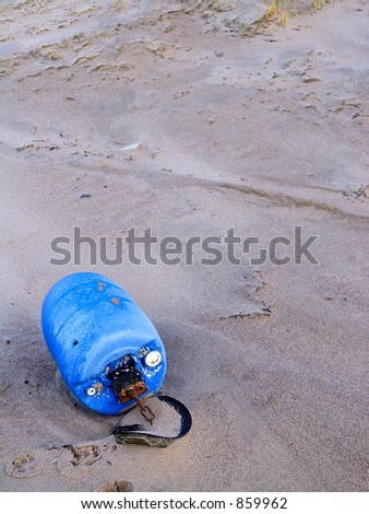Blue plastic barrel washed ashore at the beach of the west coast of Jutland, Denmark