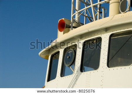 The pilot house or bridge on a commercial vessel.