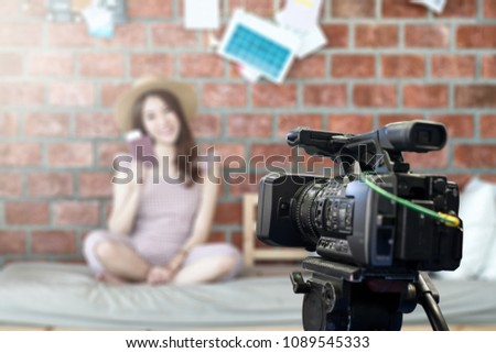 Behind the film shooting video,movie,vlog digital camera. Young beautiful asian woman taking photo,cinema broadcast television,show production maker. Entertainment news with footage equipment concept.