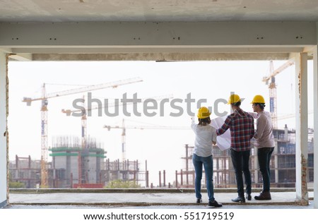 Engineer group and worker meeting, discussion with construction blueprint on site work and point finger to the site workplace