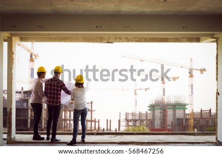 Engineer group and worker meeting, discussion with construction blueprint on site work and point finger to the site workplace